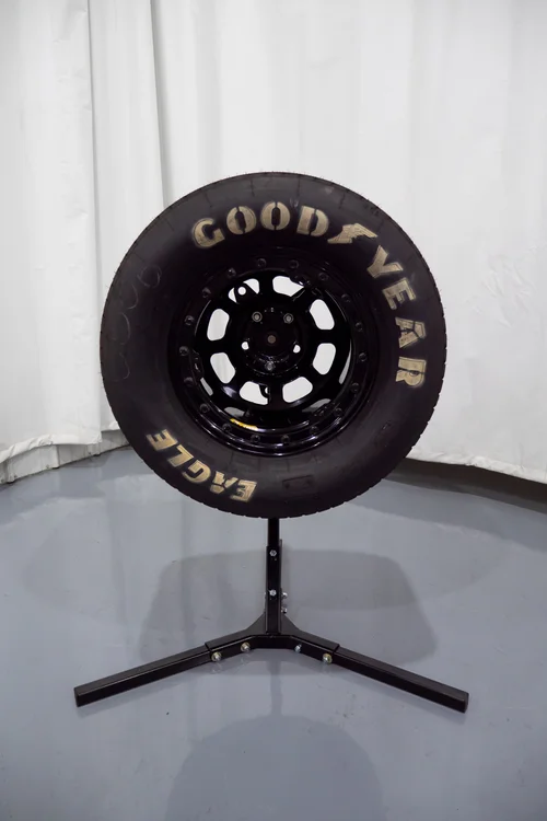 Goodyear Eagle dirt racing tire on a manual tire prep stand
